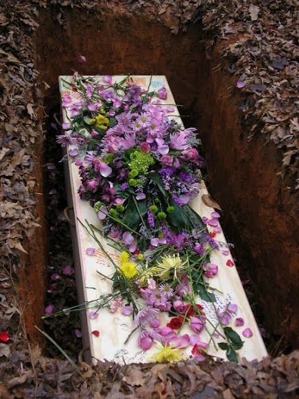 flowered casket in grave